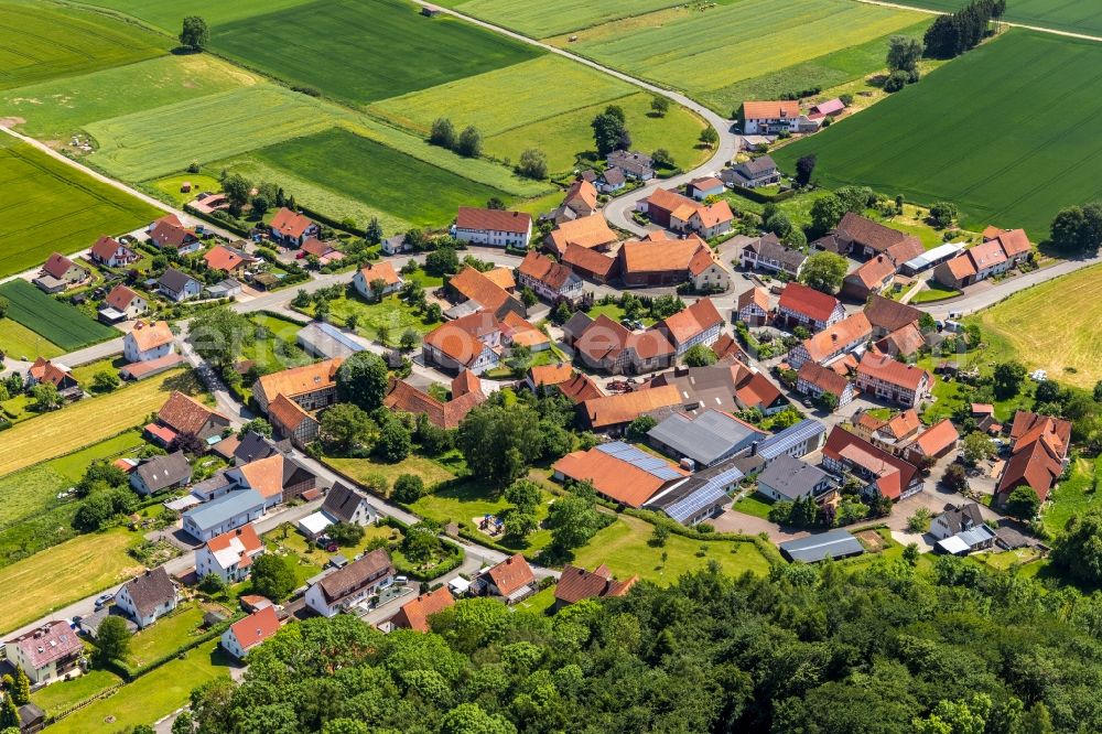 Ober-Ense from above - Agricultural land and field borders surround the settlement area of the village in Ober-Ense in the state Hesse, Germany