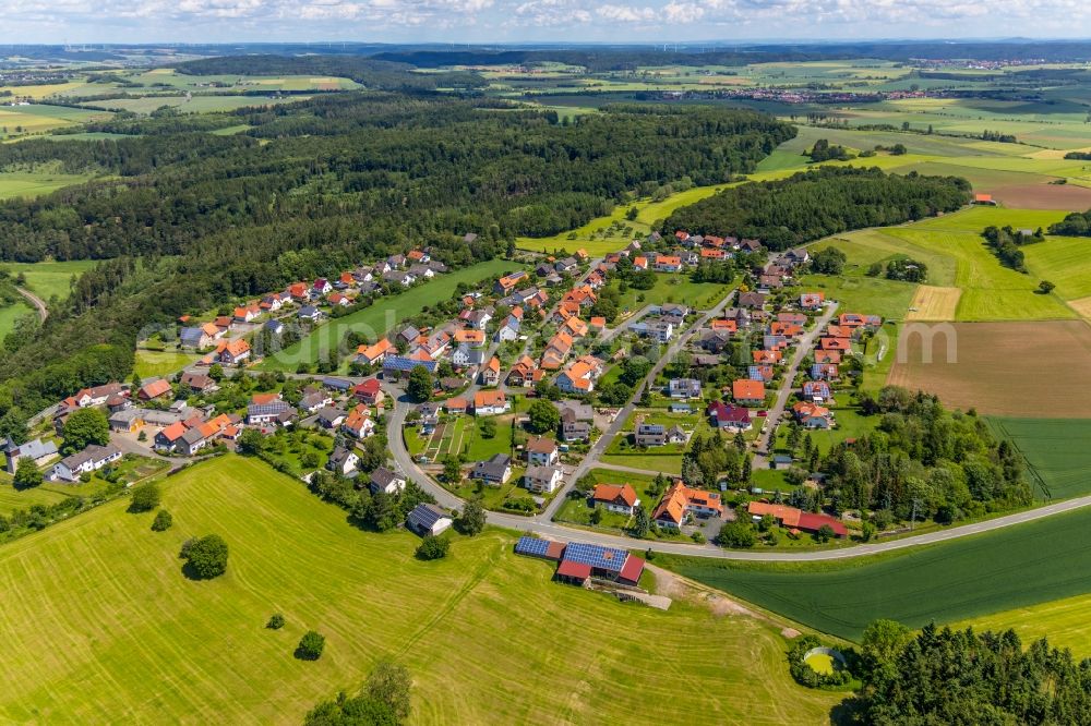 Obernburg from above - Agricultural land and field borders surround the settlement area of the village in Obernburg in the state Hesse, Germany