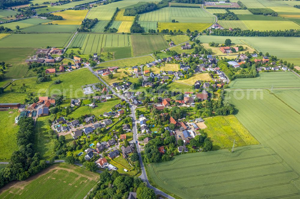 Hamm from above - Agricultural land and field borders surround the settlement area of the village in the district Osttuennen in Hamm in the state North Rhine-Westphalia, Germany