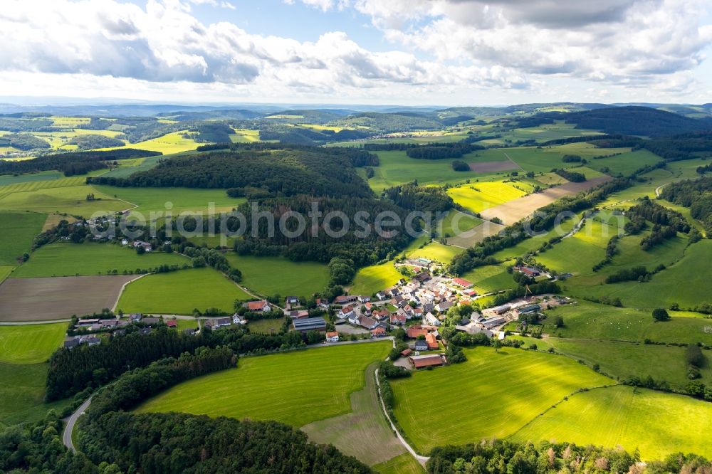 Aerial photograph Ottlar - Agricultural land and field borders surround the settlement area of the village in Ottlar in the state Hesse, Germany