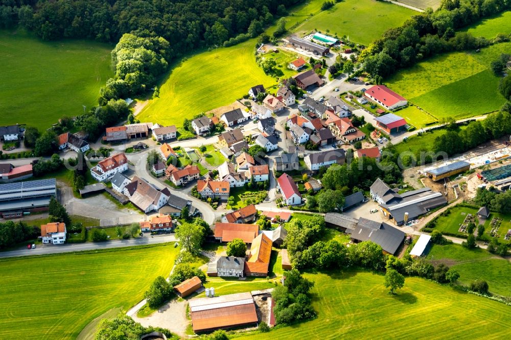 Aerial image Ottlar - Agricultural land and field borders surround the settlement area of the village in Ottlar in the state Hesse, Germany