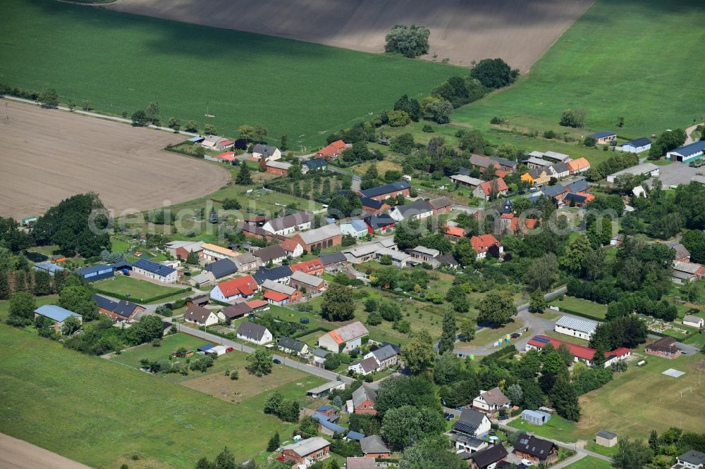 Pröttlin from above - Agricultural land and field borders surround the settlement area of the village in Proettlin in the state Brandenburg, Germany