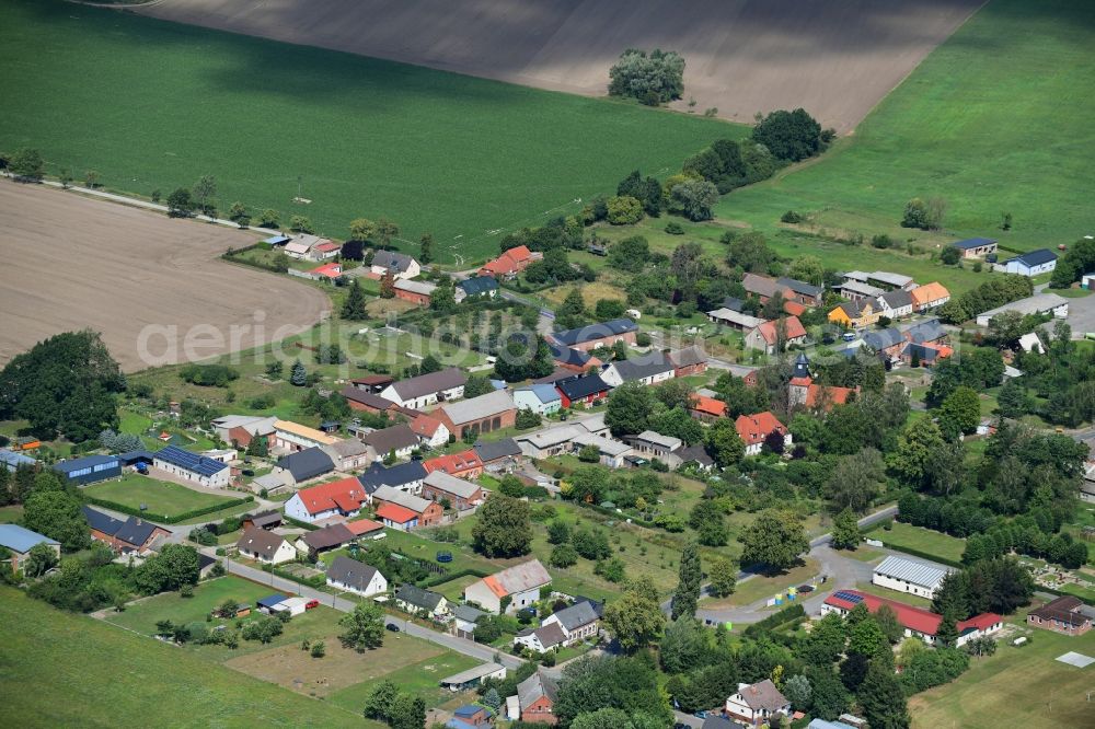 Pröttlin from above - Agricultural land and field borders surround the settlement area of the village in Proettlin in the state Brandenburg, Germany