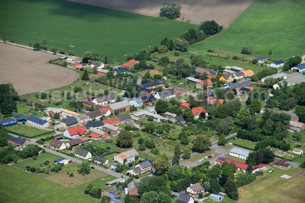 Pröttlin from the bird's eye view: Agricultural land and field borders surround the settlement area of the village in Proettlin in the state Brandenburg, Germany