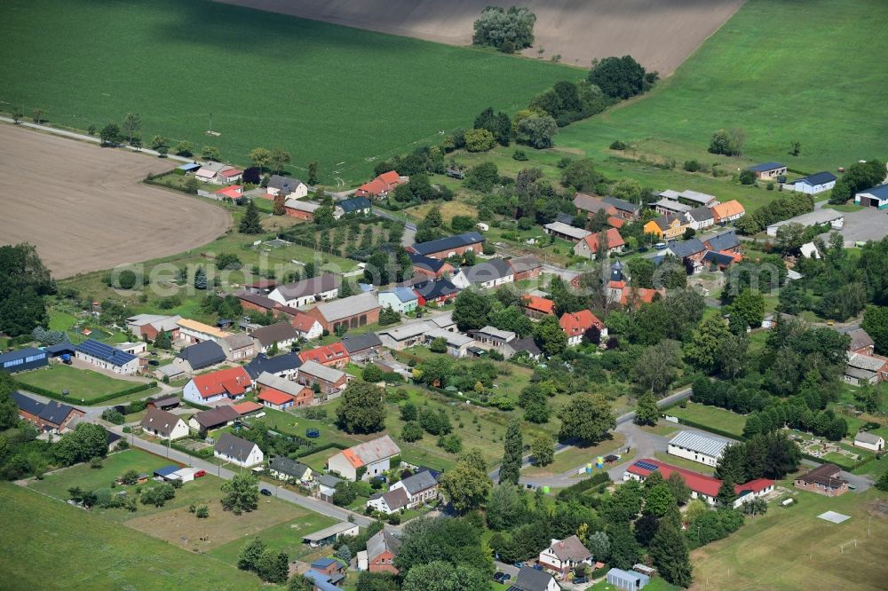 Aerial image Pröttlin - Agricultural land and field borders surround the settlement area of the village in Proettlin in the state Brandenburg, Germany