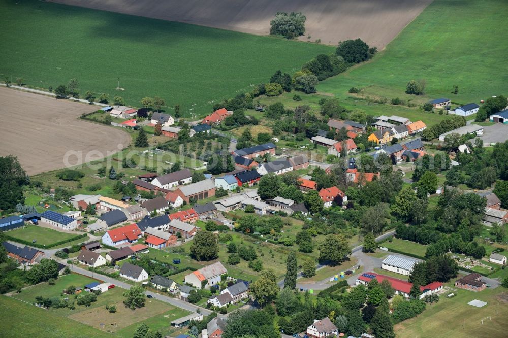 Aerial photograph Pröttlin - Agricultural land and field borders surround the settlement area of the village in Proettlin in the state Brandenburg, Germany