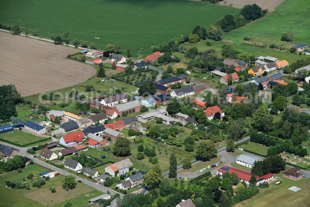 Pröttlin from above - Agricultural land and field borders surround the settlement area of the village in Proettlin in the state Brandenburg, Germany