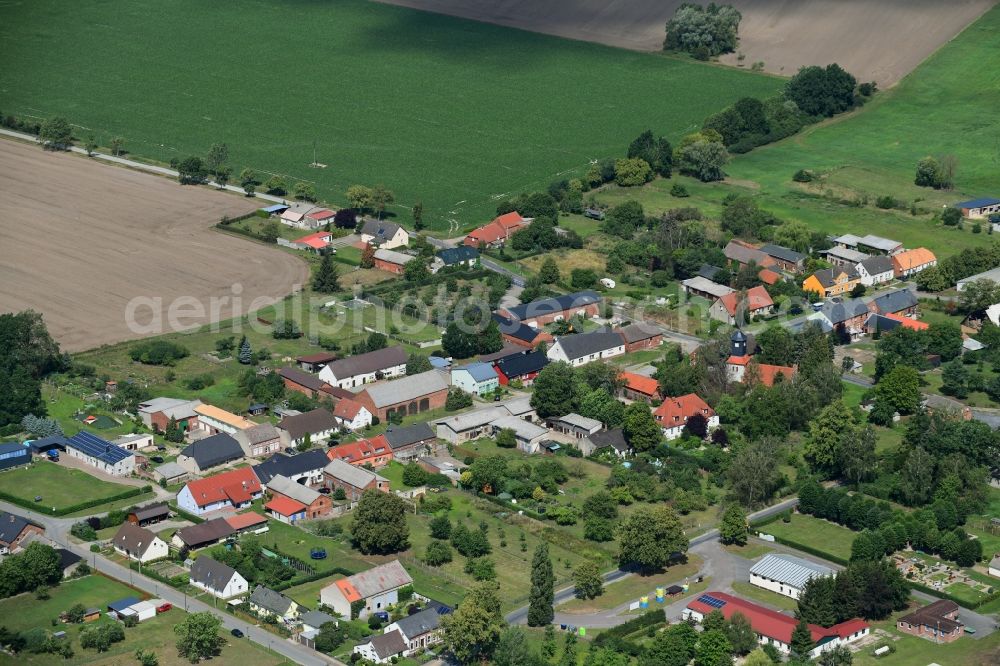 Pröttlin from the bird's eye view: Agricultural land and field borders surround the settlement area of the village in Proettlin in the state Brandenburg, Germany