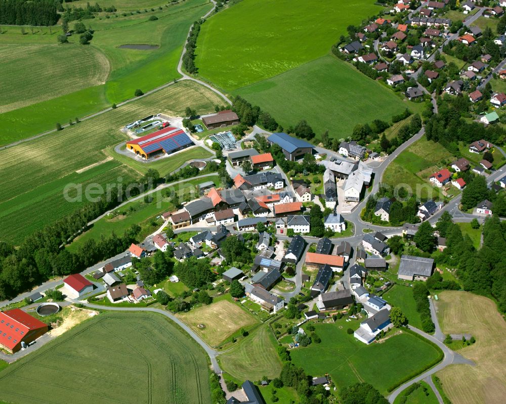 Förbau from the bird's eye view: Agricultural land and field boundaries with the power plants surround the settlement area of the village in Förbau in the state Bavaria, Germany