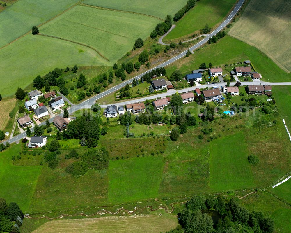 Aerial image Geroldsgrün - Agricultural land and field boundaries with the power plants surround the settlement area of the village in Geroldsgrün in the state Bavaria, Germany