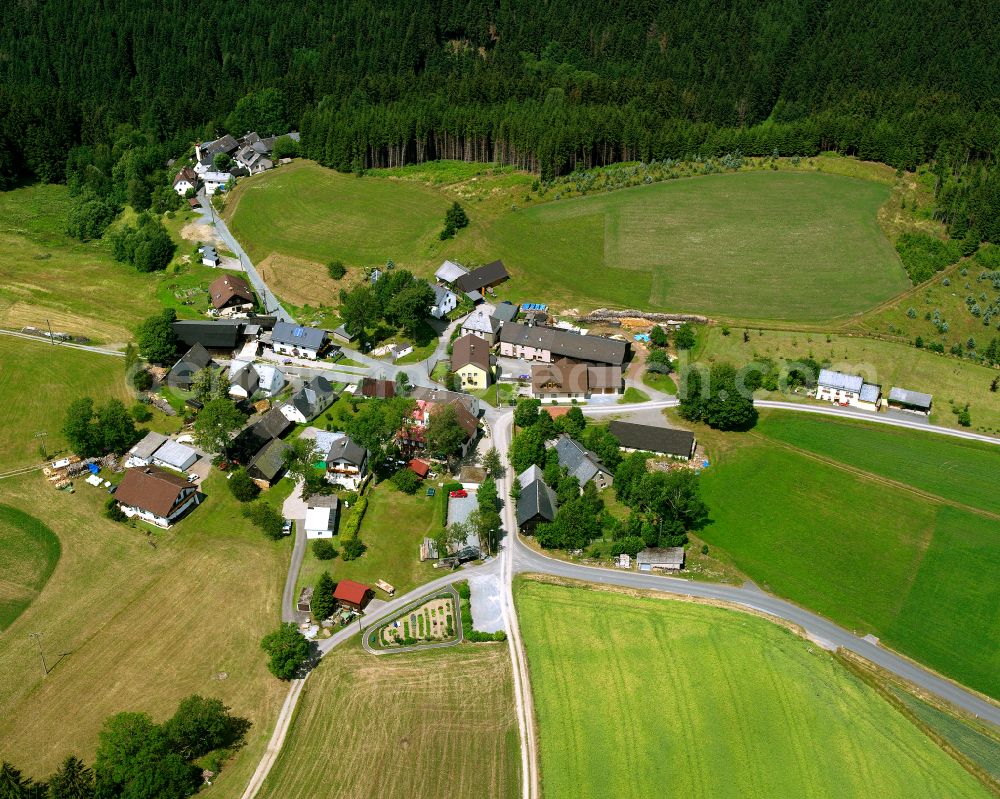 Aerial photograph Löhmar - Agricultural land and field boundaries with the power plants surround the settlement area of the village in Löhmar in the state Bavaria, Germany