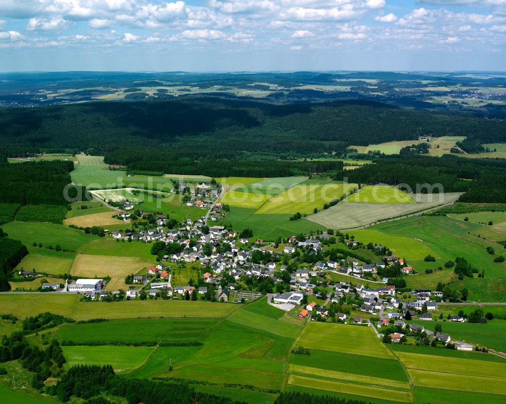 Lippertsgrün from above - Agricultural land and field boundaries with the power plants surround the settlement area of the village in Lippertsgrün in the state Bavaria, Germany