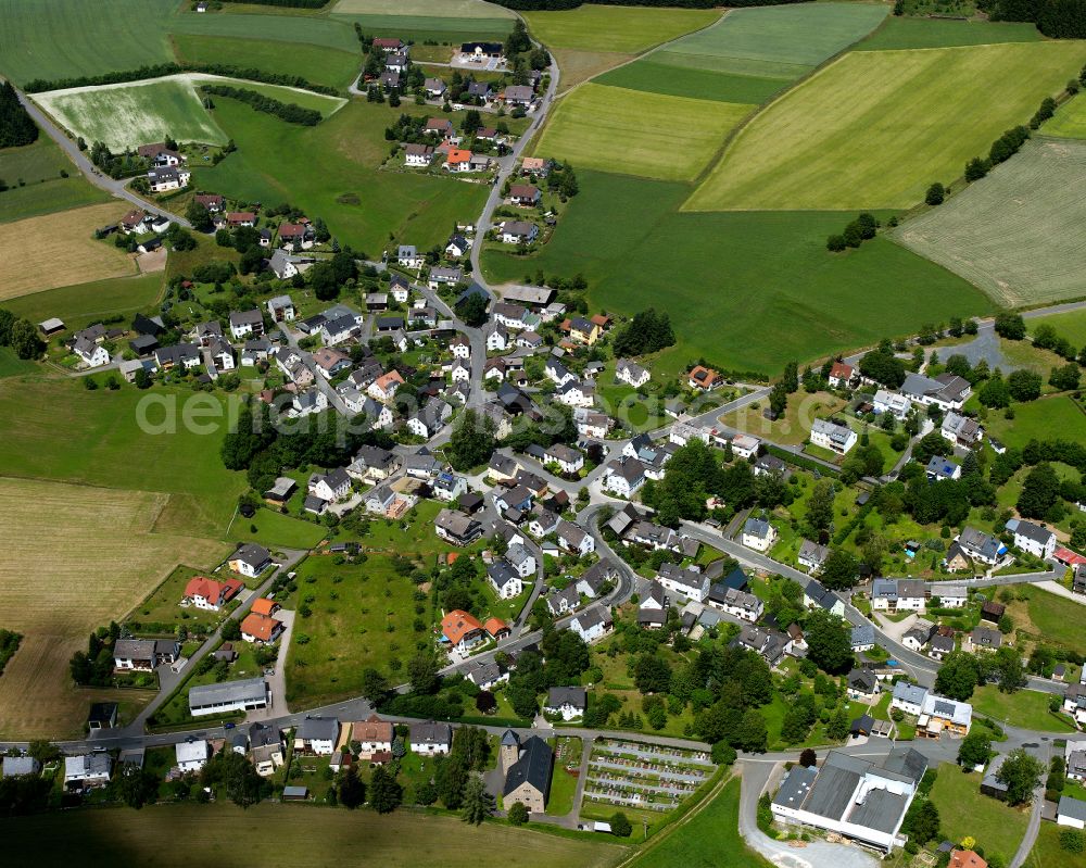 Aerial photograph Lippertsgrün - Agricultural land and field boundaries with the power plants surround the settlement area of the village in Lippertsgrün in the state Bavaria, Germany