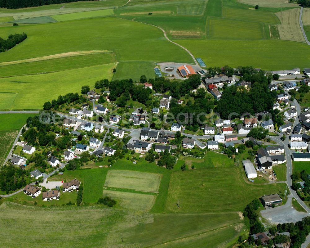 Aerial photograph Neuhaus - Agricultural land and field boundaries with the power plants surround the settlement area of the village in Neuhaus in the state Bavaria, Germany