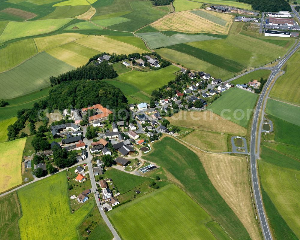 Schloßgattendorf from the bird's eye view: Agricultural land and field boundaries with the power plants surround the settlement area of the village in Schloßgattendorf in the state Bavaria, Germany