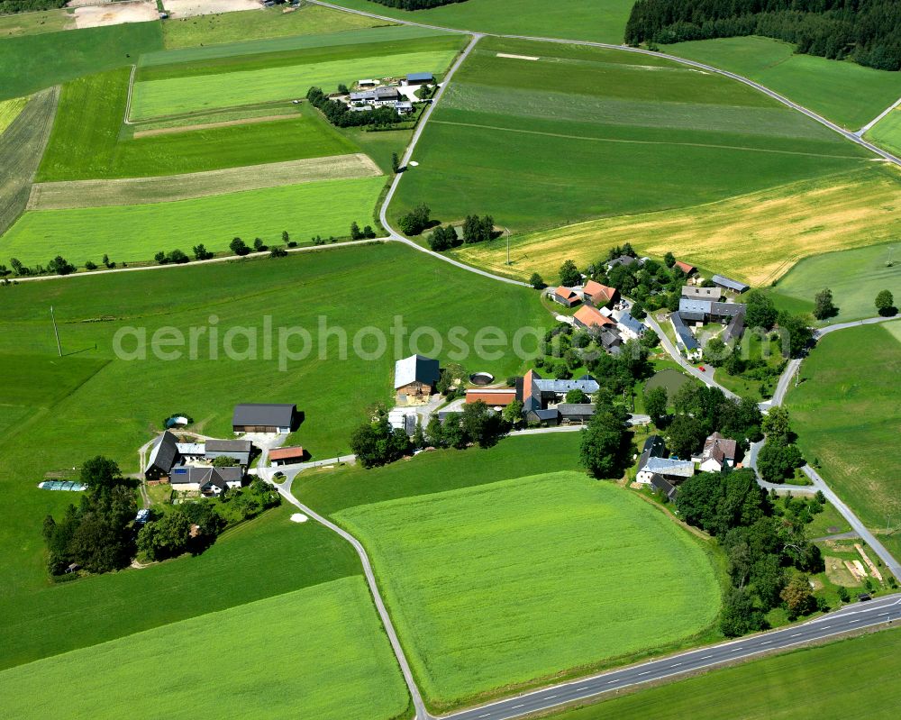 Schwarzenbach an der Saale from the bird's eye view: Agricultural land and field boundaries with the power plants surround the settlement area of the village in Schwarzenbach an der Saale in the state Bavaria, Germany