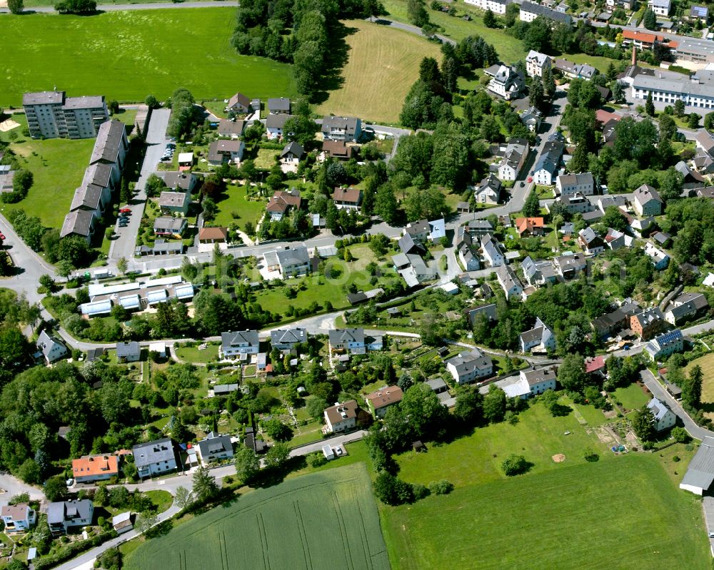 Schwarzenbach an der Saale from above - Agricultural land and field boundaries with the power plants surround the settlement area of the village in Schwarzenbach an der Saale in the state Bavaria, Germany