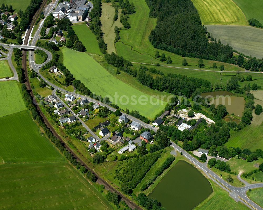 Schwarzenbach an der Saale from above - Agricultural land and field boundaries with the power plants surround the settlement area of the village in Schwarzenbach an der Saale in the state Bavaria, Germany