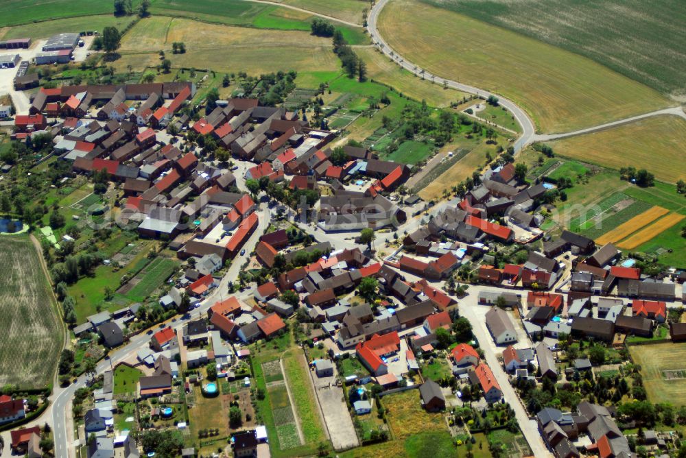 Selbitz from the bird's eye view: Agricultural land and field boundaries with the power plants surround the settlement area of the village on street Dorfstrasse in Selbitz in the state Saxony-Anhalt, Germany