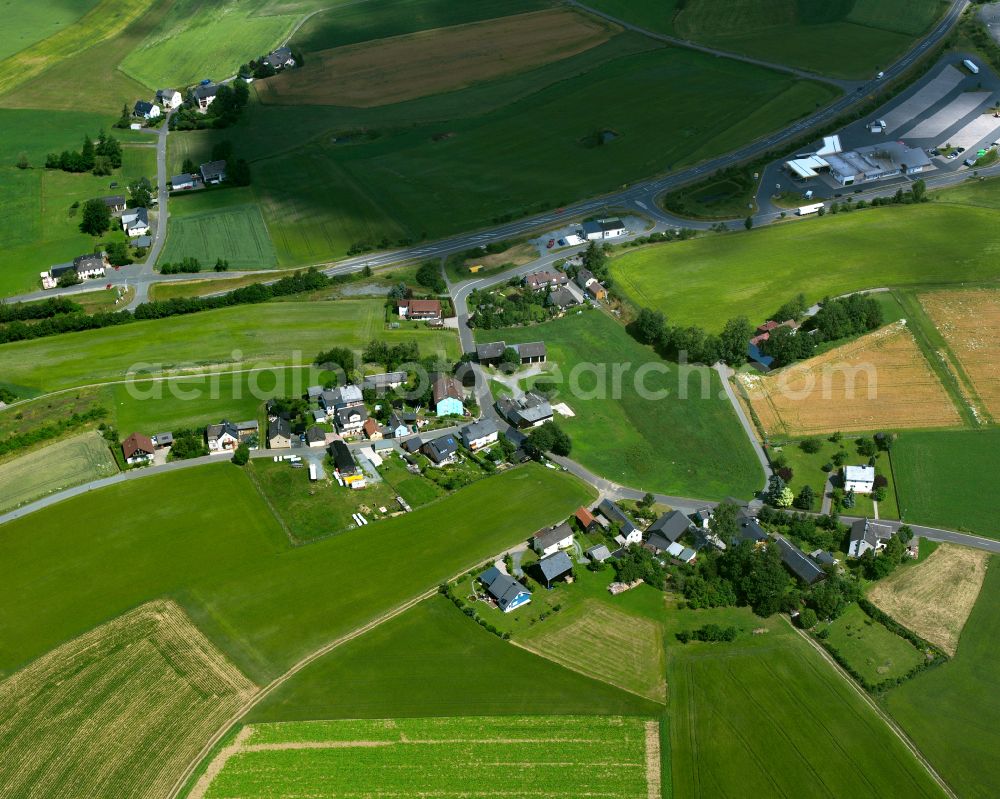 Sellanger from above - Agricultural land and field boundaries with the power plants surround the settlement area of the village in Sellanger in the state Bavaria, Germany