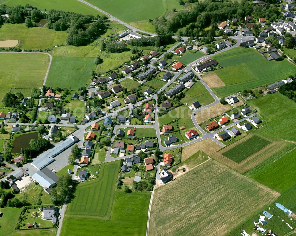 Aerial image Sparneck - Agricultural land and field boundaries with the power plants surround the settlement area of the village in Sparneck in the state Bavaria, Germany