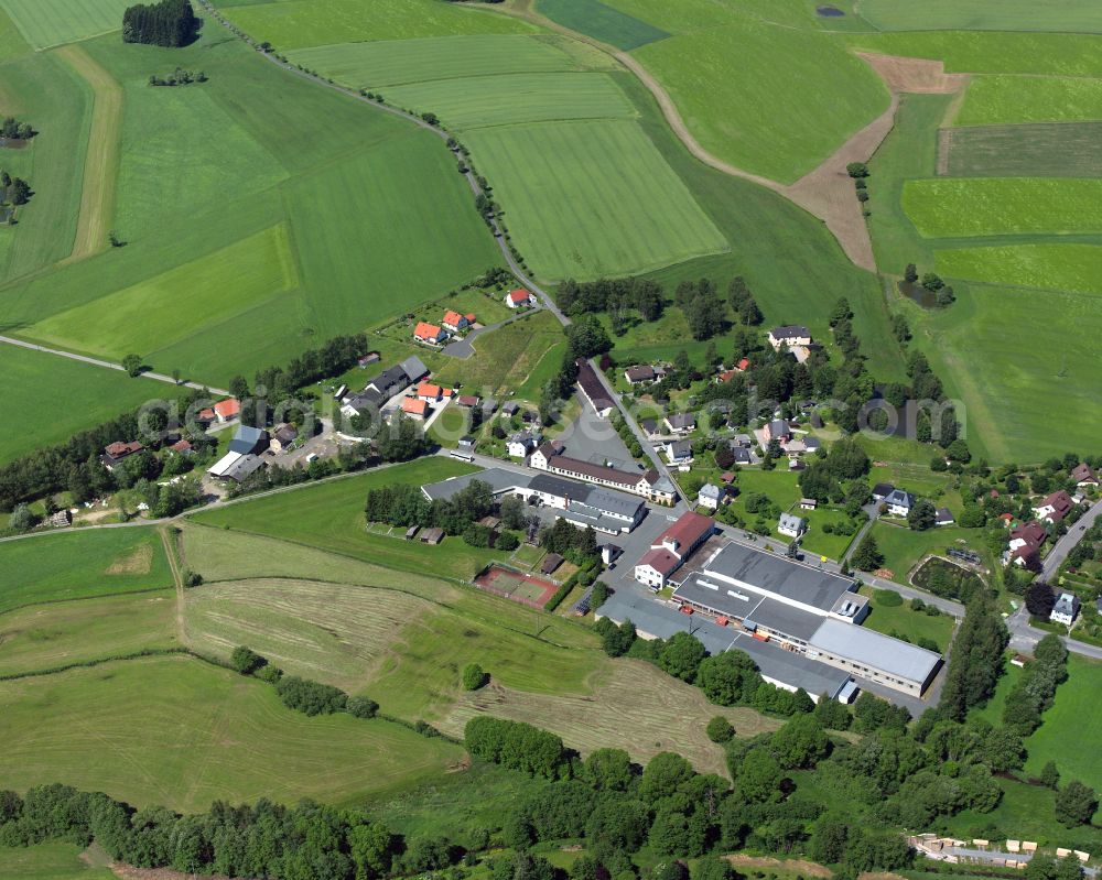 Aerial image Weißdorf - Agricultural land and field boundaries with the power plants surround the settlement area of the village in Weißdorf in the state Bavaria, Germany