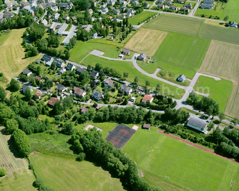 Aerial photograph Weißdorf - Agricultural land and field boundaries with the power plants surround the settlement area of the village in Weißdorf in the state Bavaria, Germany