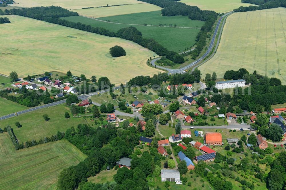 Aerial photograph Retzin - Agricultural land and field borders surround the settlement area of the village in Retzin in the state Brandenburg, Germany