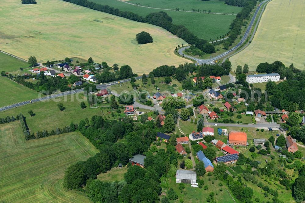 Retzin from above - Agricultural land and field borders surround the settlement area of the village in Retzin in the state Brandenburg, Germany