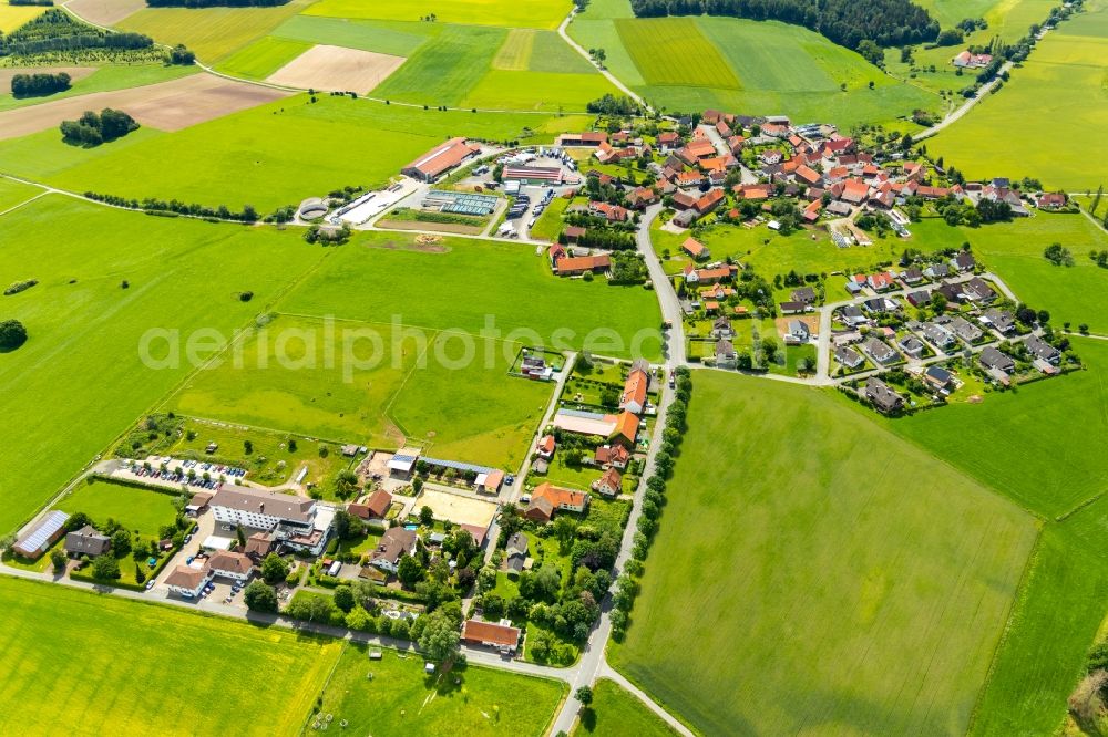 Aerial image Rhadern - Agricultural land and field borders surround the settlement area of the village in Rhadern in the state Hesse, Germany