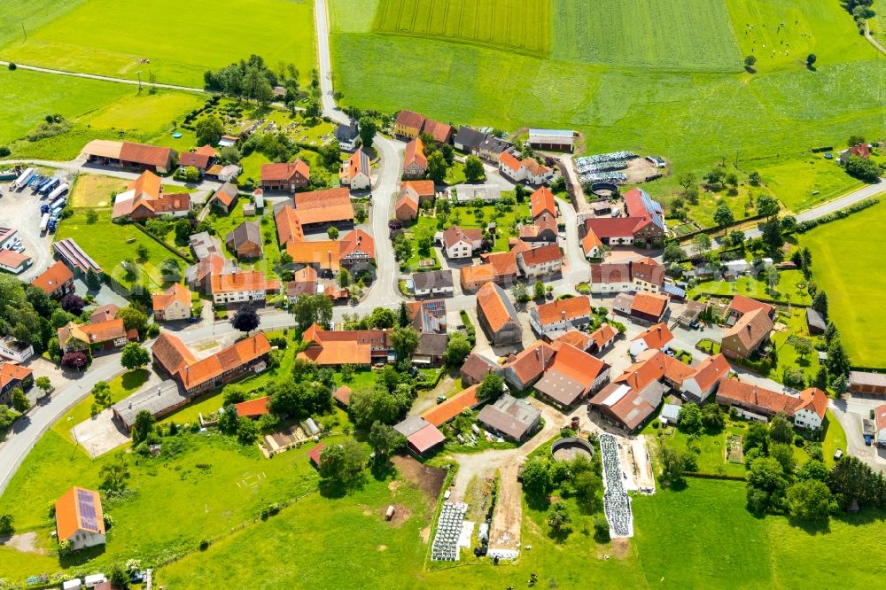 Aerial photograph Rhadern - Agricultural land and field borders surround the settlement area of the village in Rhadern in the state Hesse, Germany