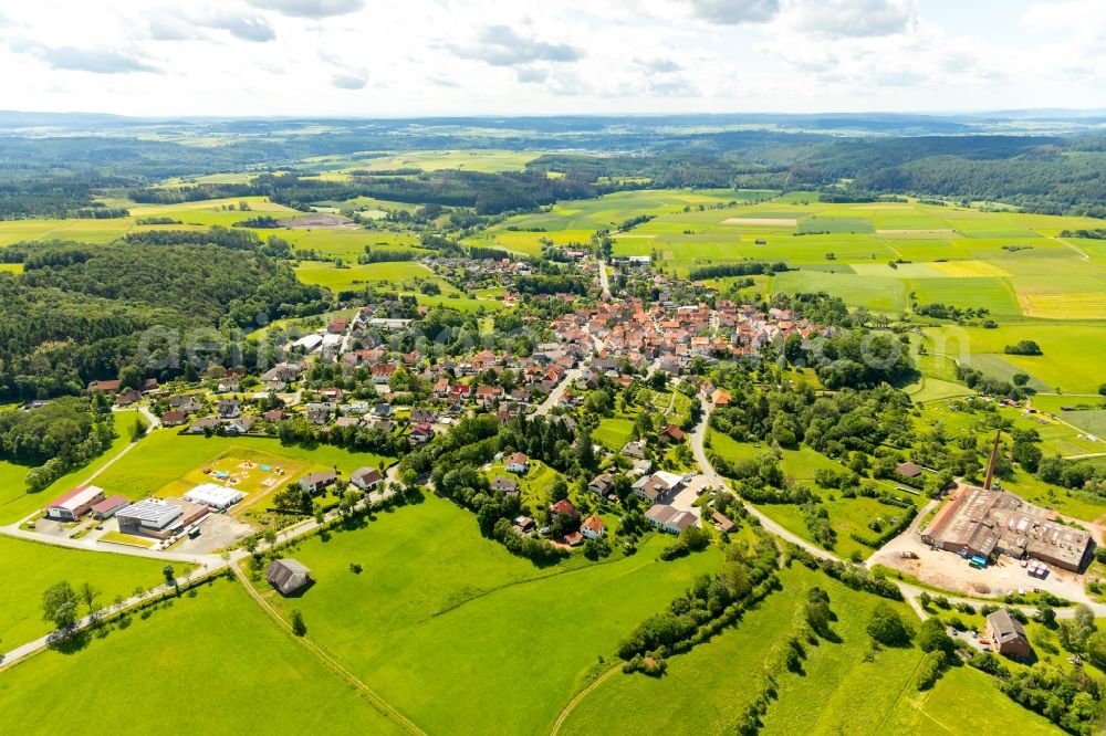 Sachsenberg from above - Agricultural land and field borders surround the settlement area of the village in Sachsenberg in the state Hesse, Germany