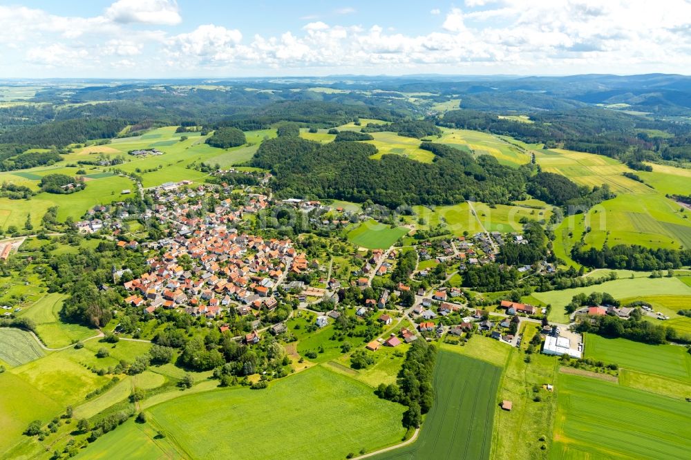 Aerial image Sachsenberg - Agricultural land and field borders surround the settlement area of the village in Sachsenberg in the state Hesse, Germany