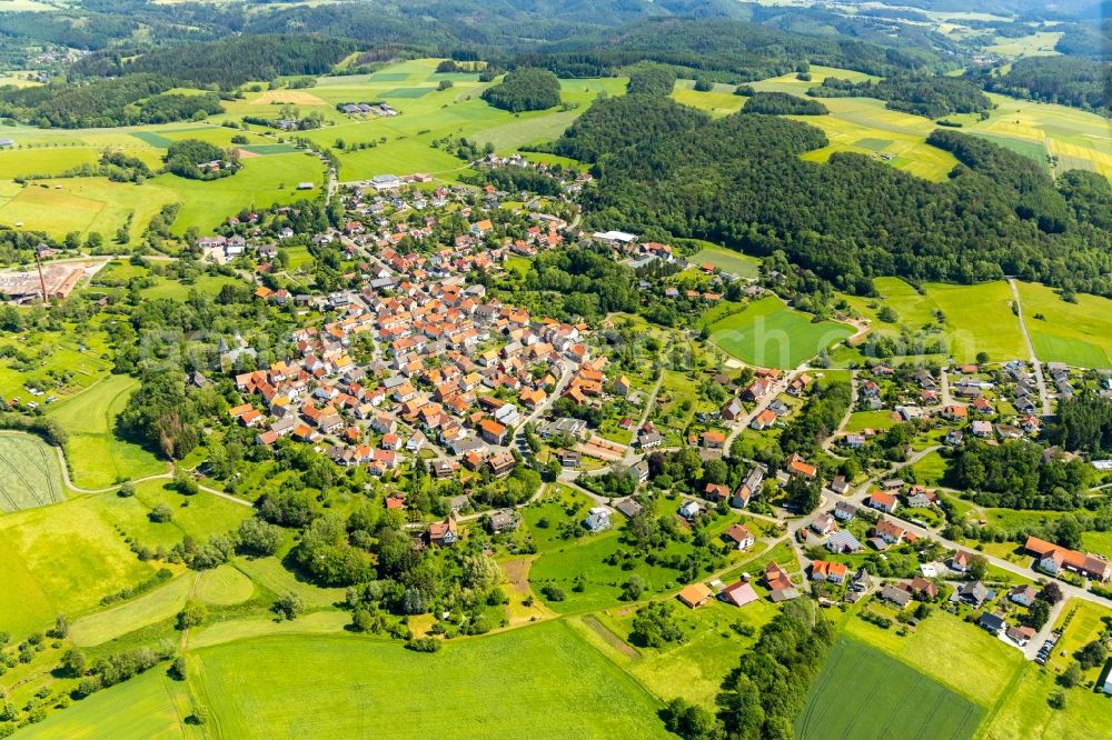 Sachsenberg from above - Agricultural land and field borders surround the settlement area of the village in Sachsenberg in the state Hesse, Germany