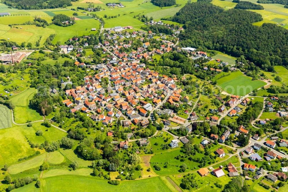 Sachsenberg from the bird's eye view: Agricultural land and field borders surround the settlement area of the village in Sachsenberg in the state Hesse, Germany