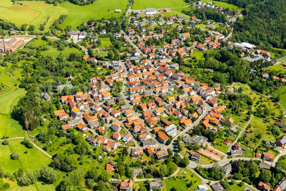 Aerial image Sachsenberg - Agricultural land and field borders surround the settlement area of the village in Sachsenberg in the state Hesse, Germany