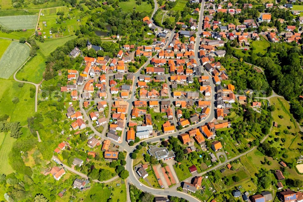 Sachsenberg from above - Agricultural land and field borders surround the settlement area of the village in Sachsenberg in the state Hesse, Germany