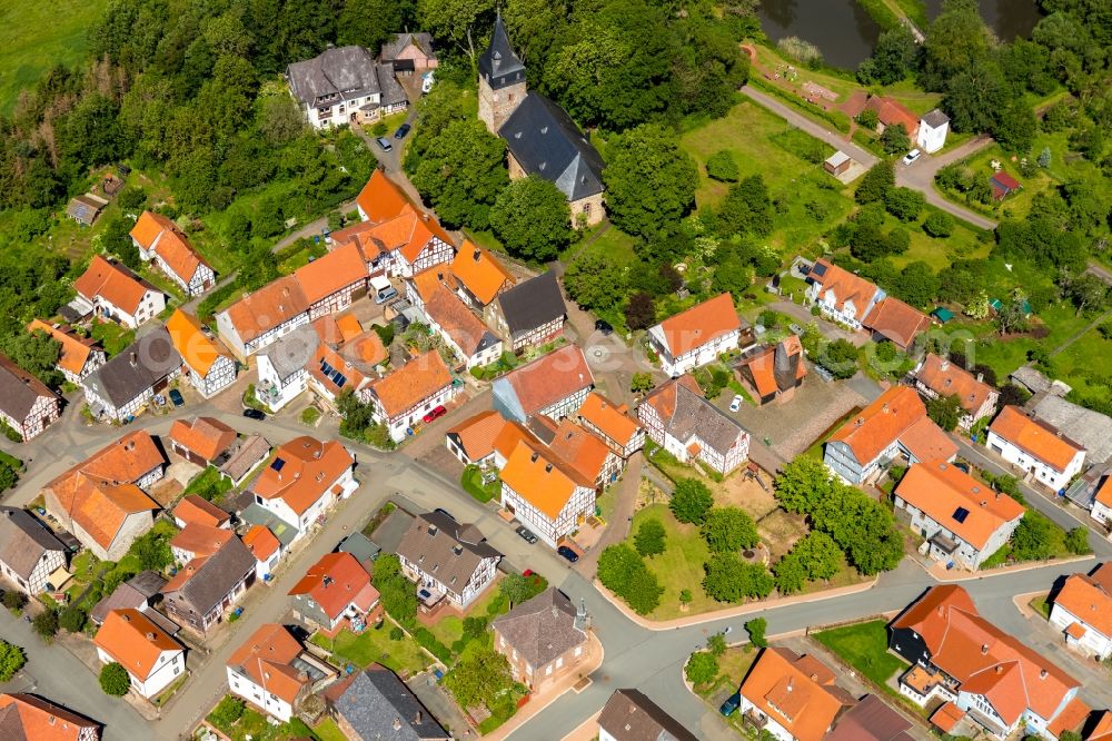 Sachsenberg from the bird's eye view: Agricultural land and field borders surround the settlement area of the village in Sachsenberg in the state Hesse, Germany