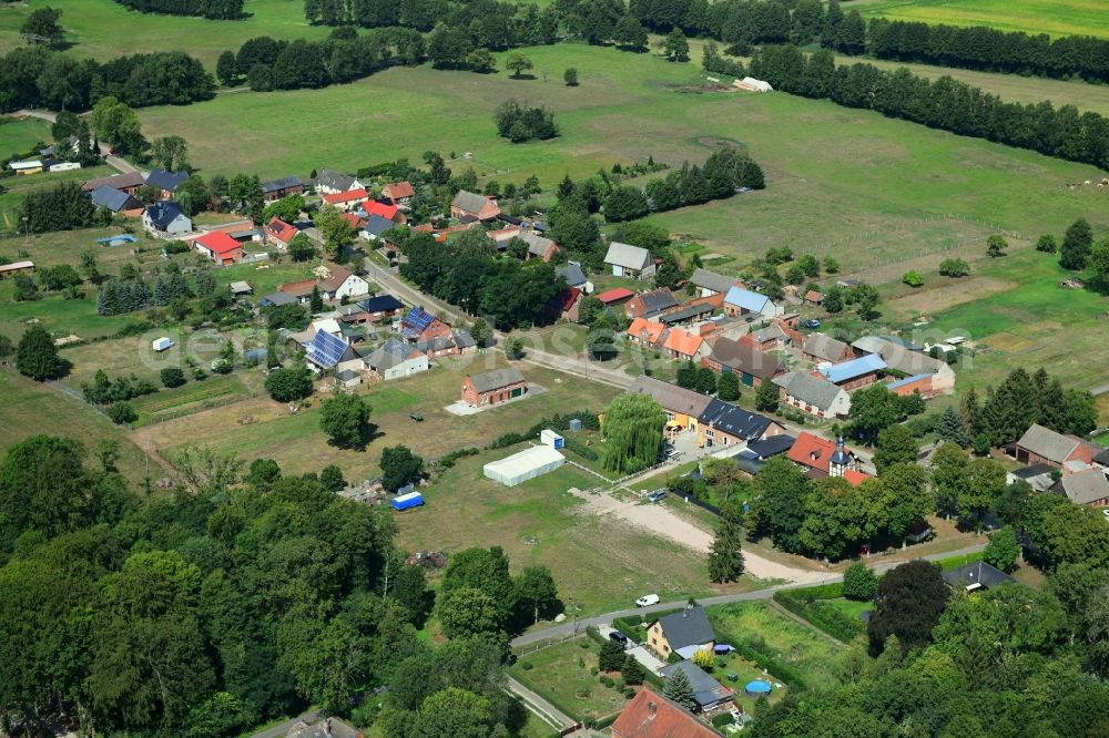 Schilde from the bird's eye view: Agricultural land and field borders surround the settlement area of the village in Schilde in the state Brandenburg, Germany