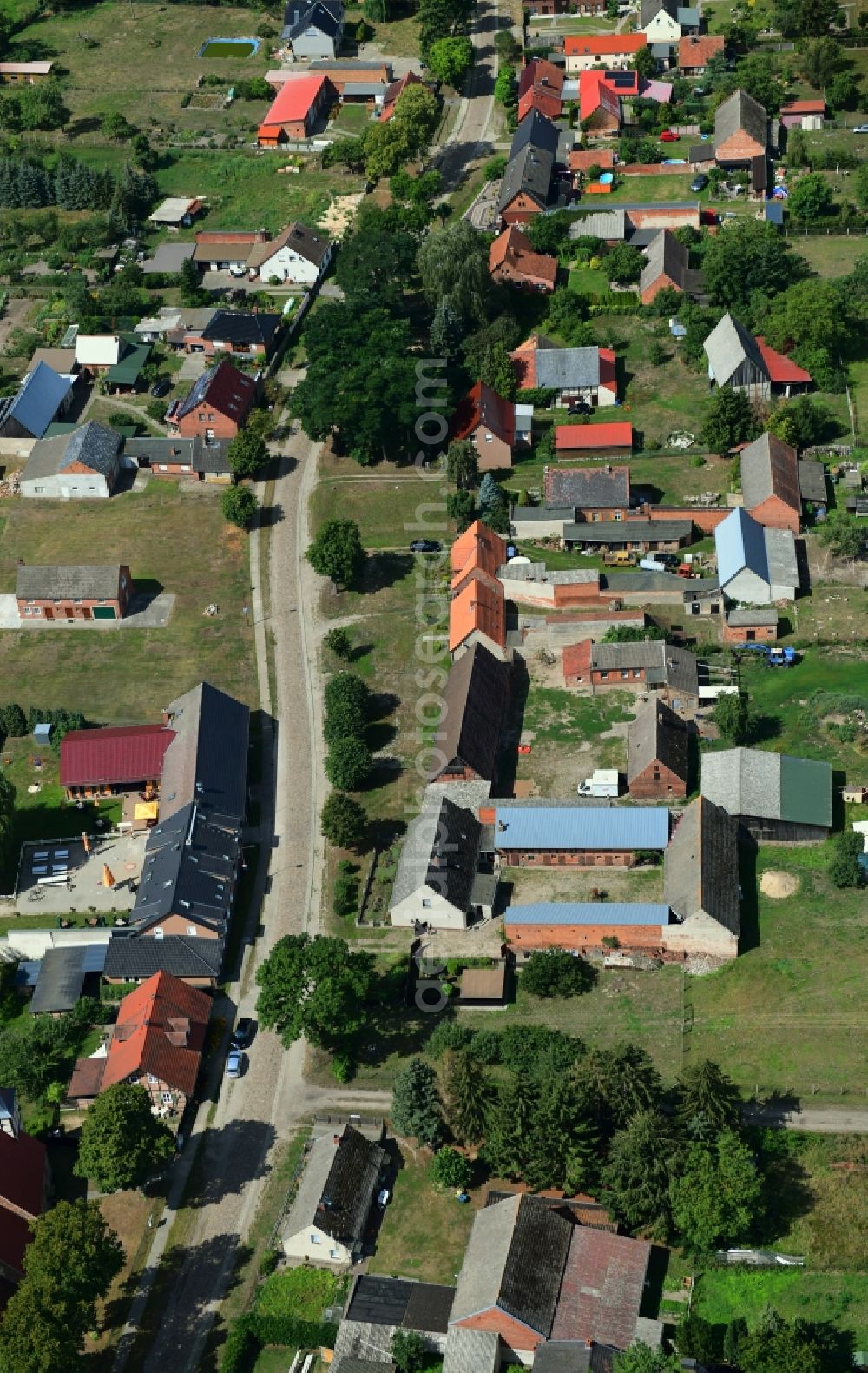 Schilde from the bird's eye view: Agricultural land and field borders surround the settlement area of the village in Schilde in the state Brandenburg, Germany