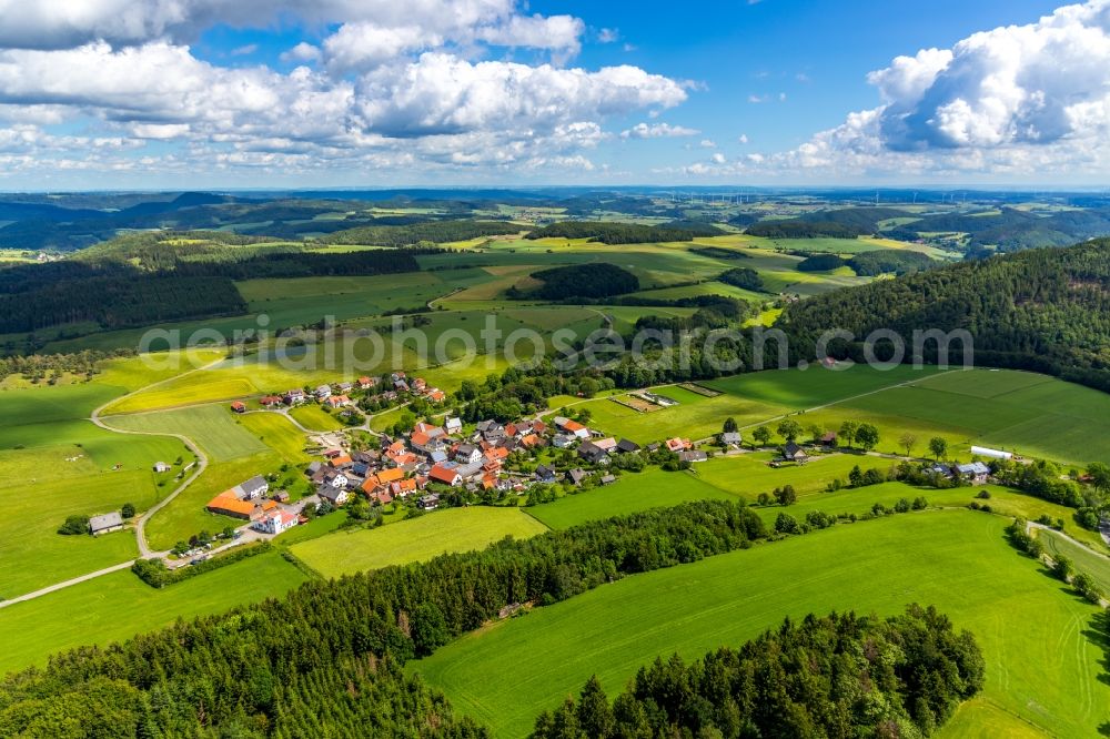 Schweinsbühl from above - Agricultural land and field borders surround the settlement area of the village in Schweinsbuehl in the state Hesse, Germany