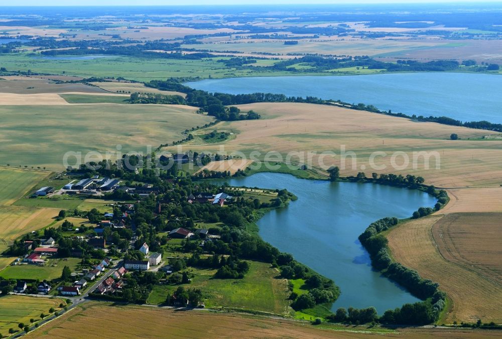 Seelübbe from the bird's eye view: Village on the lake bank areas of Seeluebber See in Seeluebbe in the state Brandenburg, Germany