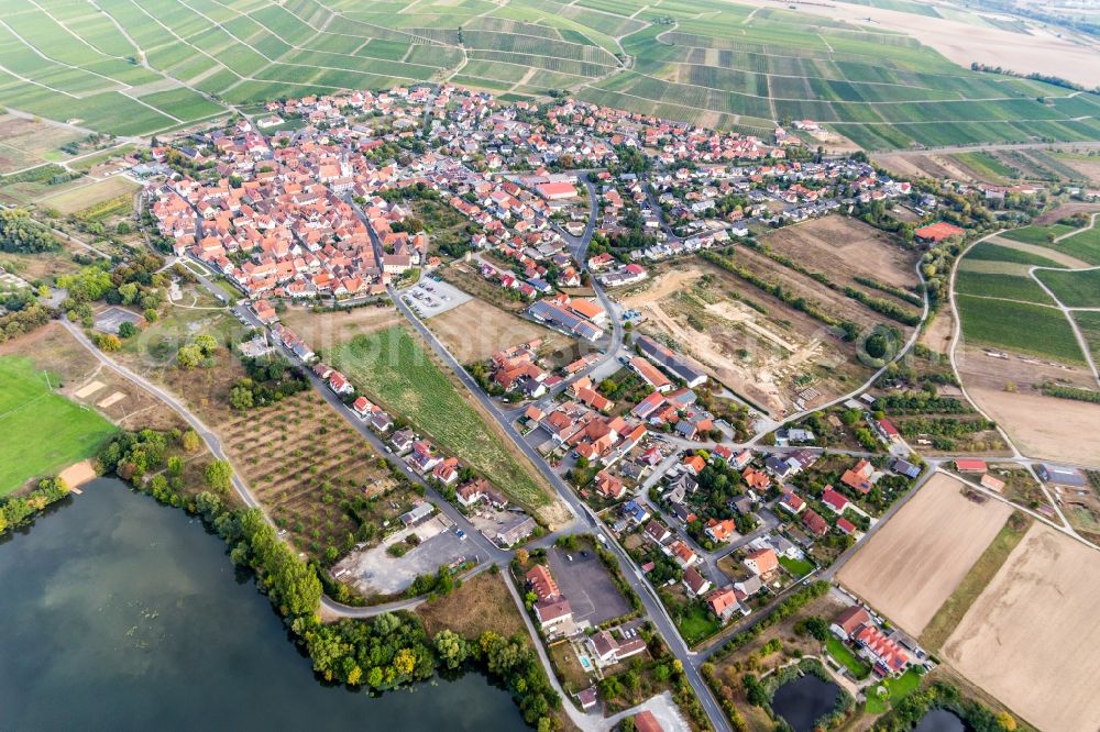 Sommerach from the bird's eye view: Agricultural land and field borders surround the settlement area of the village in Sommerach in the state Bavaria, Germany