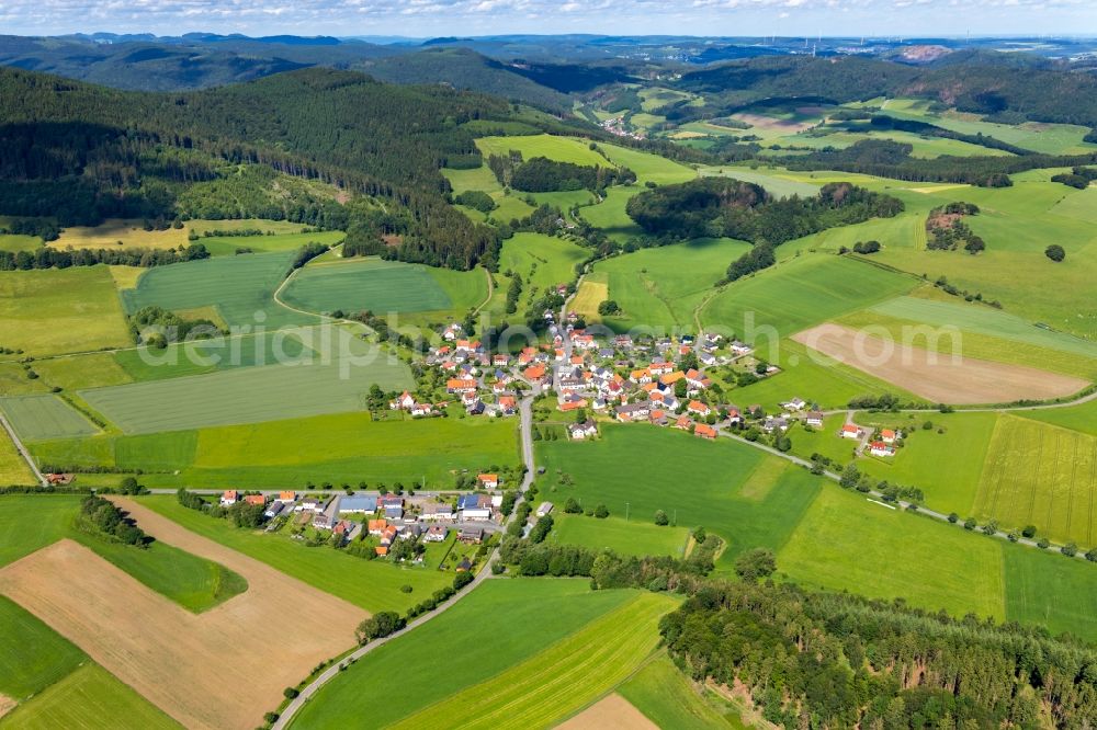 Stormbruch from the bird's eye view: Agricultural land and field borders surround the settlement area of the village in Stormbruch in the state Hesse, Germany