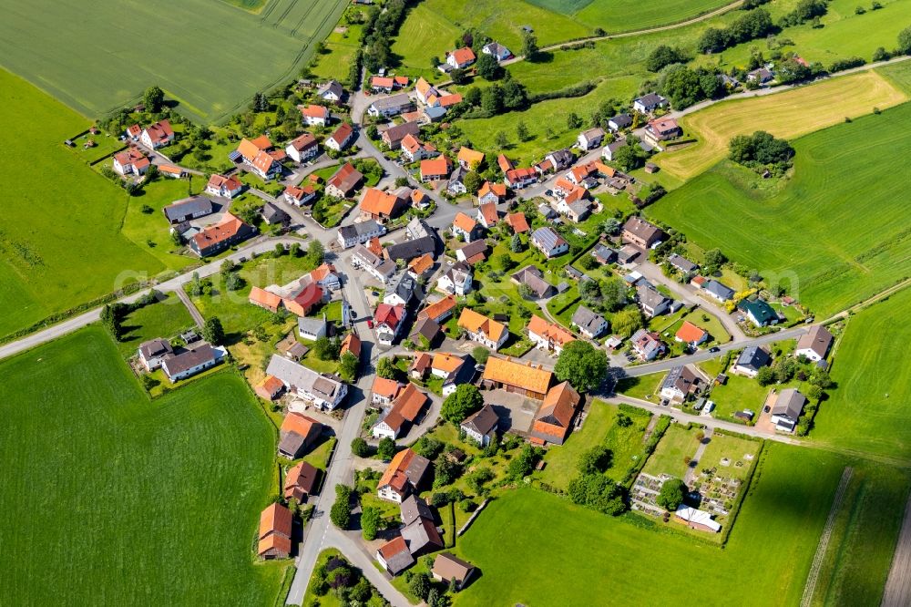 Aerial photograph Stormbruch - Agricultural land and field borders surround the settlement area of the village in Stormbruch in the state Hesse, Germany