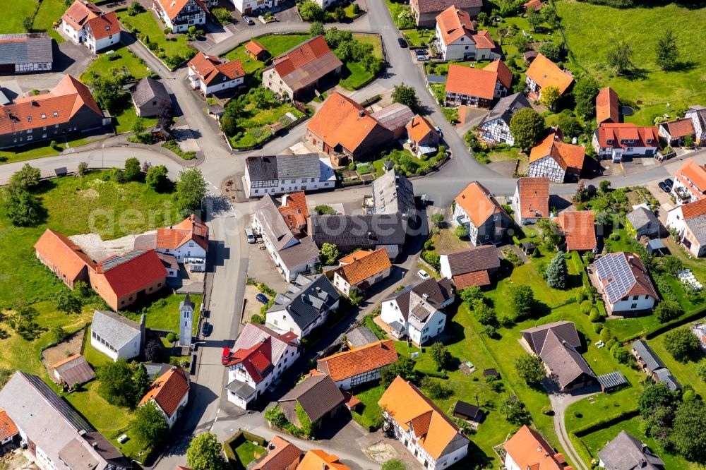 Stormbruch from above - Agricultural land and field borders surround the settlement area of the village in Stormbruch in the state Hesse, Germany