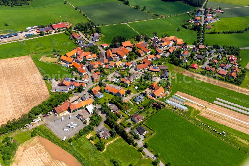 Strothe from the bird's eye view: Agricultural land and field borders surround the settlement area of the village in Strothe in the state Hesse, Germany