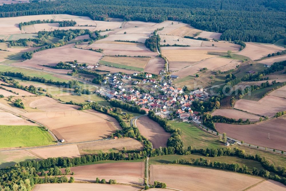 Theinheim from above - Agricultural land and field borders surround the settlement area of the village in Theinheim in the state Bavaria, Germany