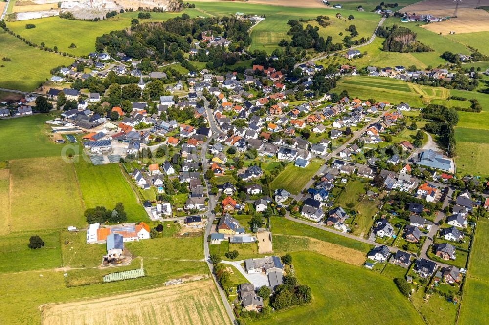 Aerial image Thülen - Agricultural land and field borders surround the settlement area of the village in Thuelen in the state North Rhine-Westphalia, Germany