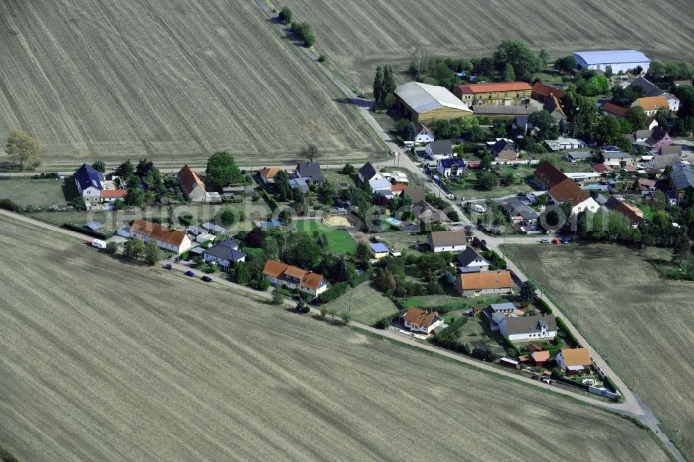 Torna from above - Agricultural land and field borders surround the settlement area of the village in Torna in the state Saxony-Anhalt, Germany